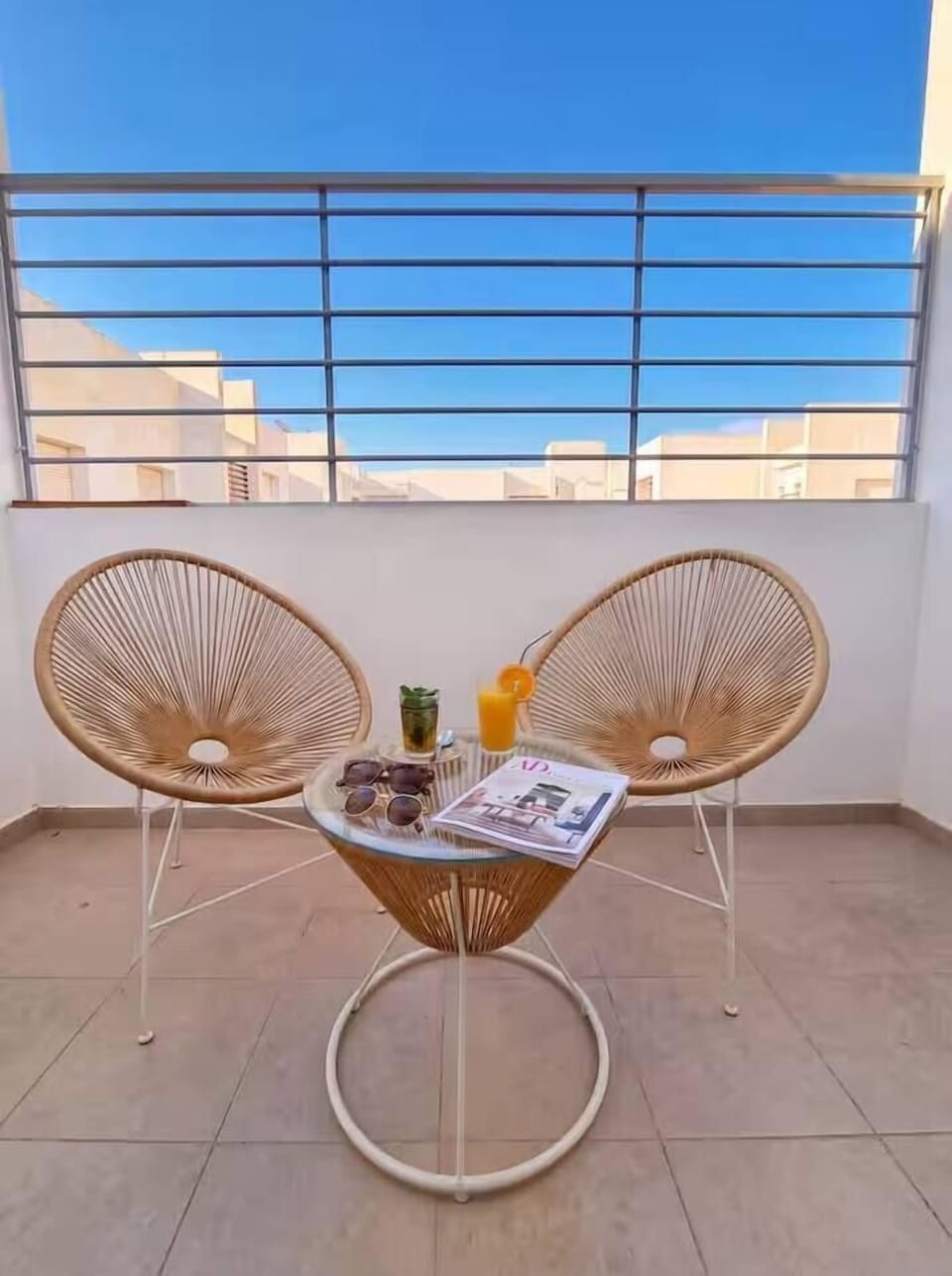Private balcony seating area at this DHAJIA Morocco stay, ideal for morning coffee, fresh air or a quiet moment during your visit.