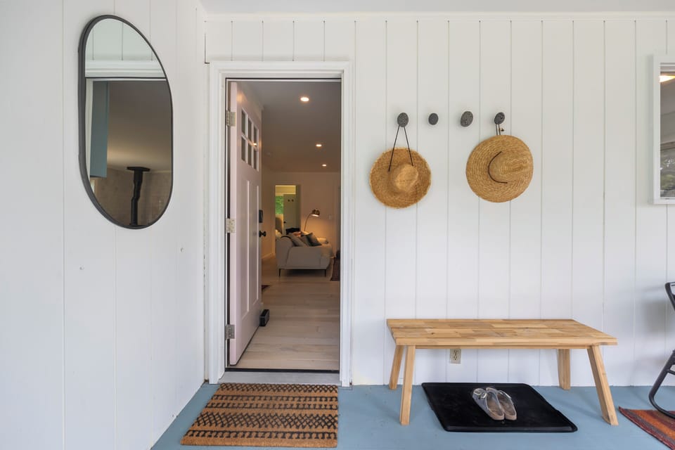 Welcoming porch entry with stylish decor and bright indoor views
