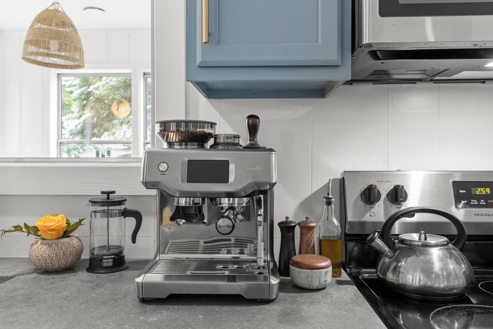Bright kitchen coffee station with espresso machine and modern finishes