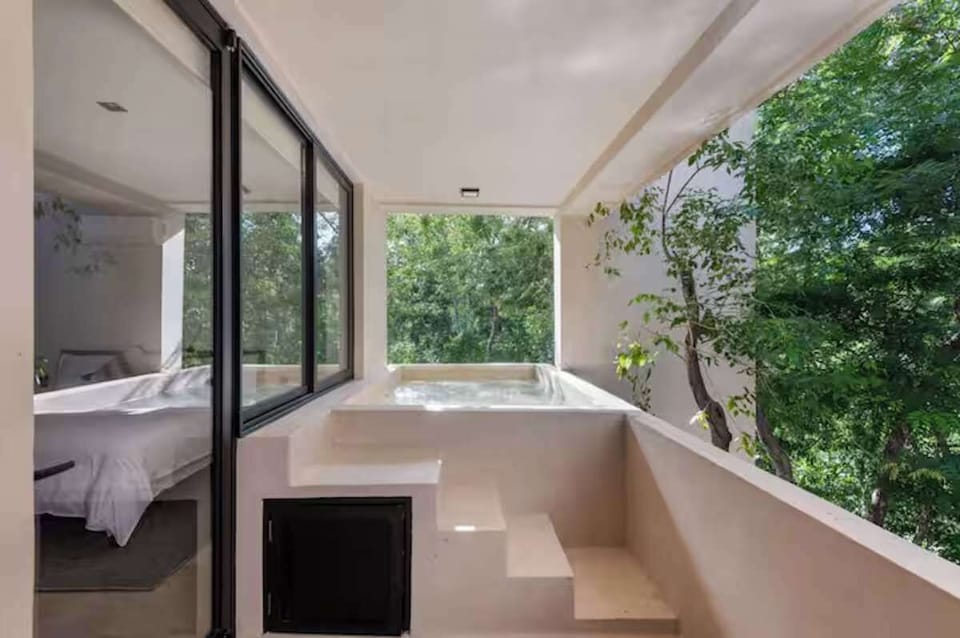 Wake up in paradise. Enjoy ultimate privacy with a chic, modern bedroom that flows directly into your exclusive jungle-view pool floating above the trees.
