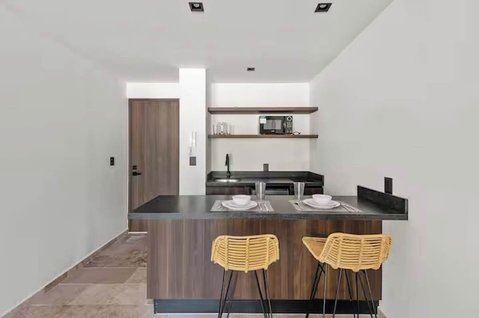 Morning coffee spot. A beautifully crafted breakfast bar with local wooden accents and stylish seating for two, perfect for remote work.