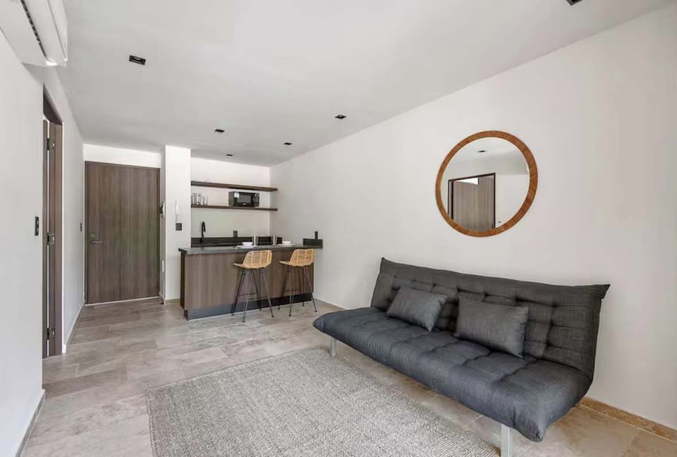 Elegant and cozy living room. A separate, bright space designed with local wood textures and organic materials to relax after a day at the beach.