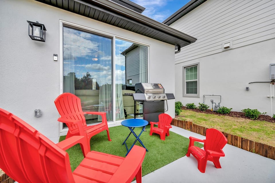 Adirondack chairs arranged around the backyard patio