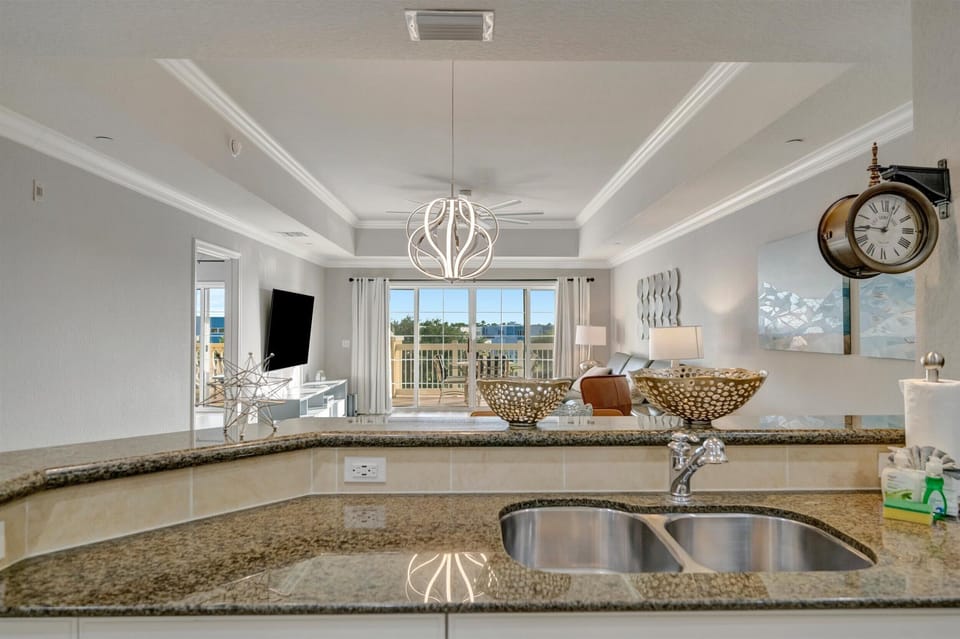 Granite breakfast bar connecting kitchen and living room