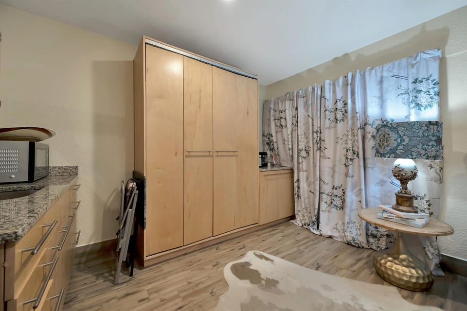Floor-to-ceiling wardrobe for luggage, clothing, and extended stays