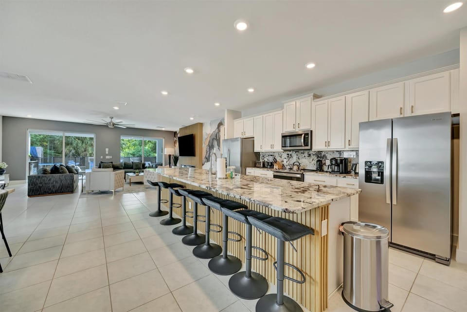 Long breakfast bar with seating for 8 guests. Luxury countertops and stainless steel appliances - plenty of space for entertaining