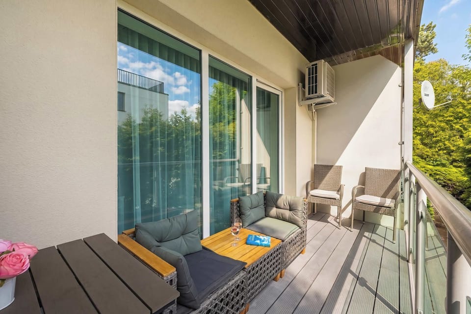Private Balcony with Outdoor Lounge Furniture and Green Surroundings