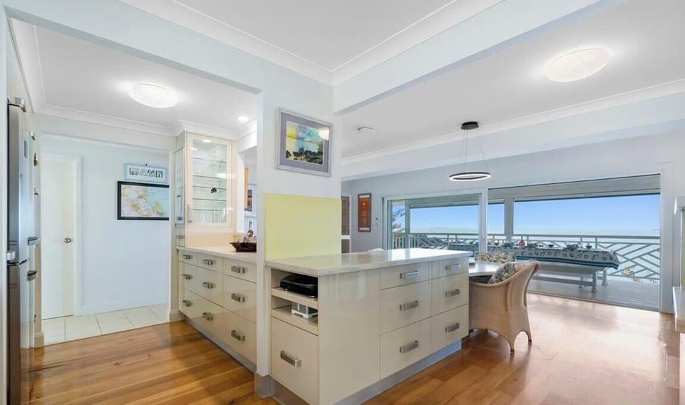 A fully equipped kitchen with oven, stove, drawer warmer, steam oven and microwave, plus everything you need to cook and entertain. Enjoy the 4-seater dining table inside or dine alfresco outdoors.