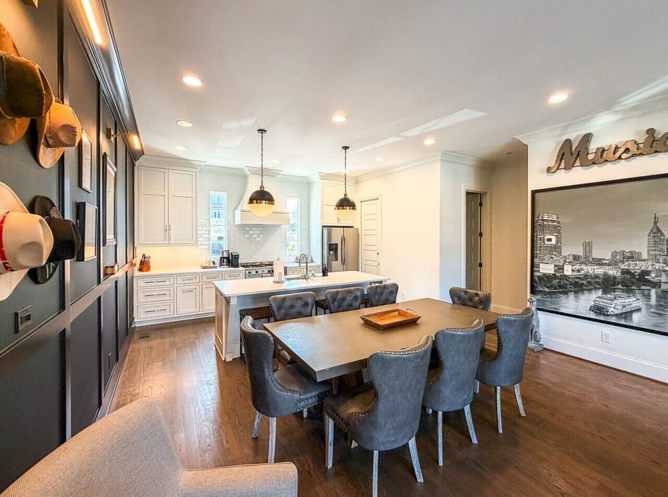 Eight person dining table in addition to four stools at the eat in kitchen, plenty of space to enjoy meals together