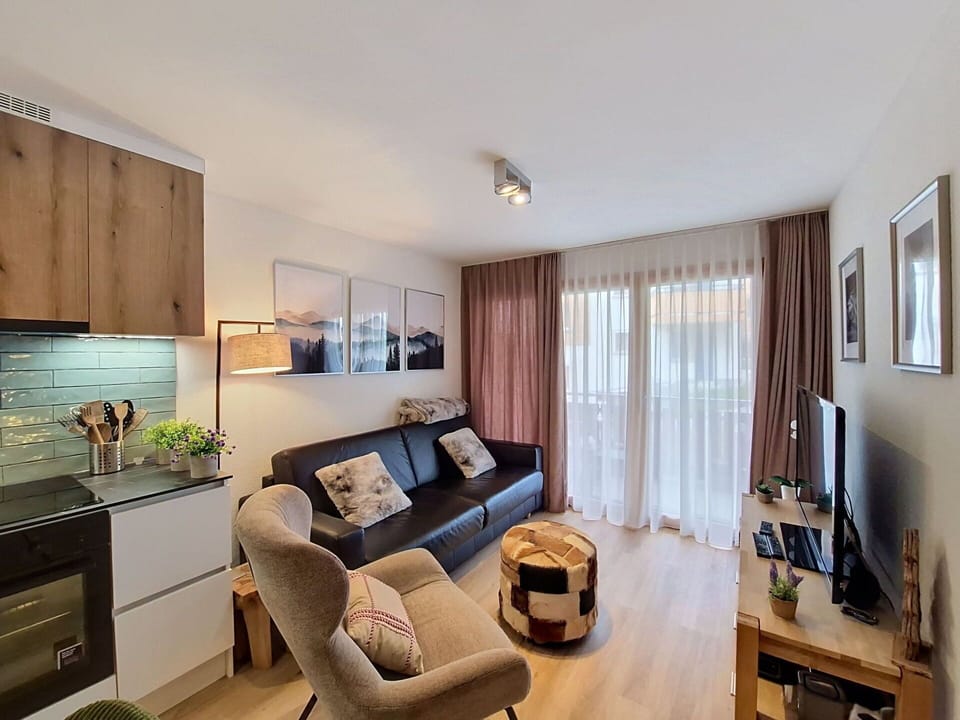 Furniture, Interior Design, Flooring, Wood, Floor, Room, Ceiling, Apartment, Couch, Lighting