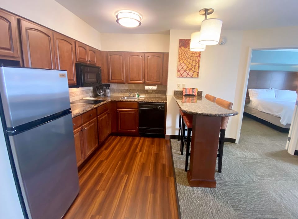 Cook up a storm in this fully equipped kitchen featuring sleek granite countertops and modern appliances.