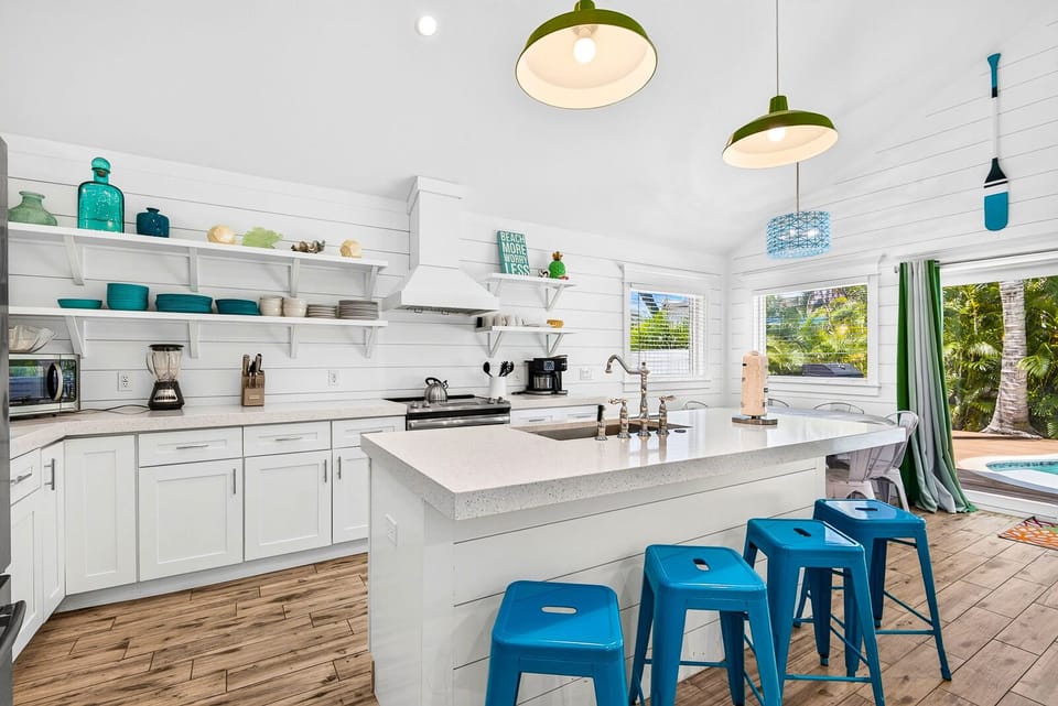 Bright coastal kitchen with island seating and tropical views