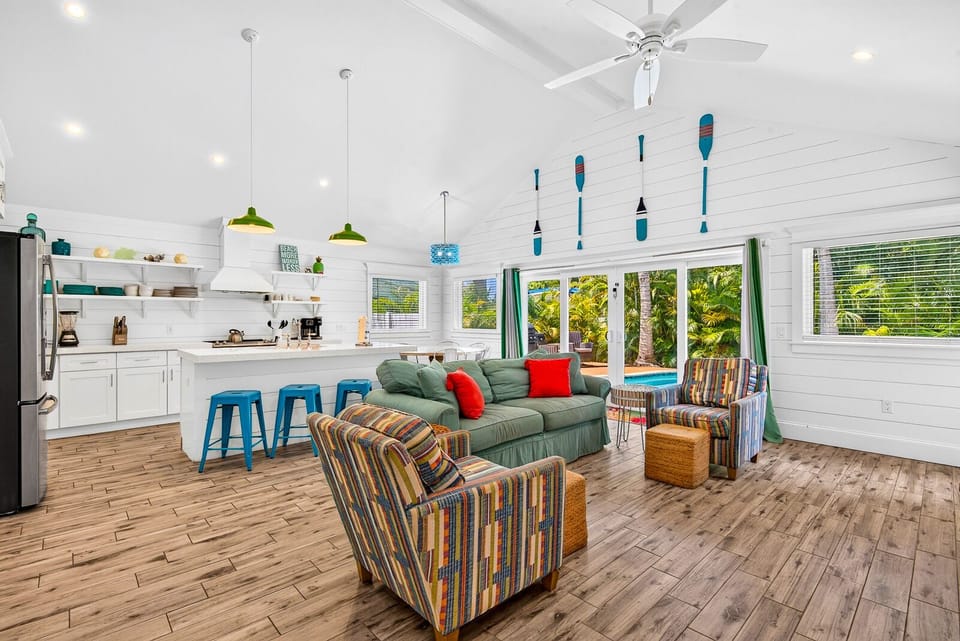 Bright tropical great room with open kitchen and indoor-outdoor feel