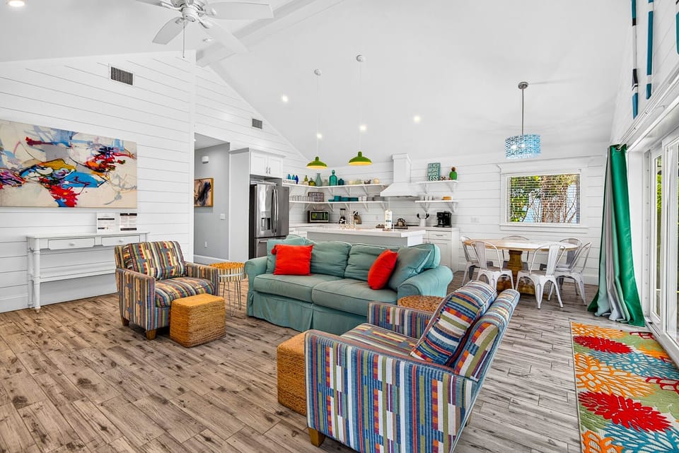 Bright open living space with vaulted ceilings and cheerful coastal style