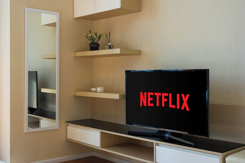 Modern TV lounge with Netflix, sleek shelving, and a bright airy feel