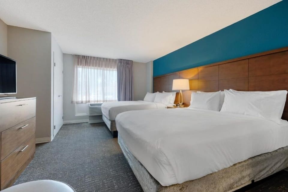 Unwind in crisp linens with twin beds and soft light.