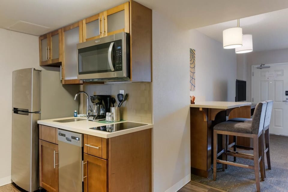Brew morning coffee and prep snacks with full kitchenette convenience.