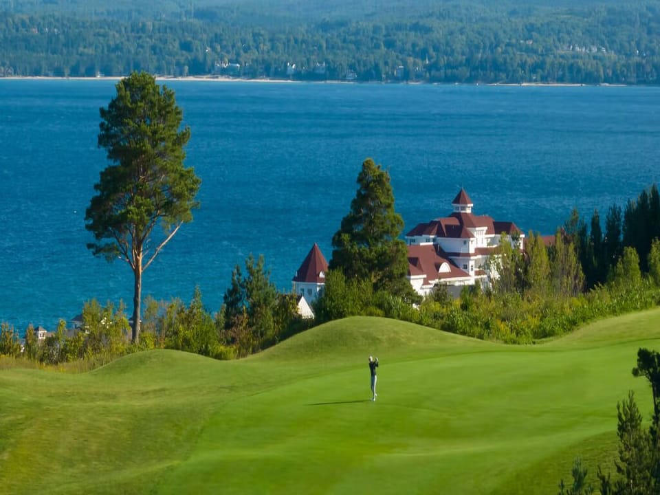 Soak in sweeping lake views beyond lush greens.