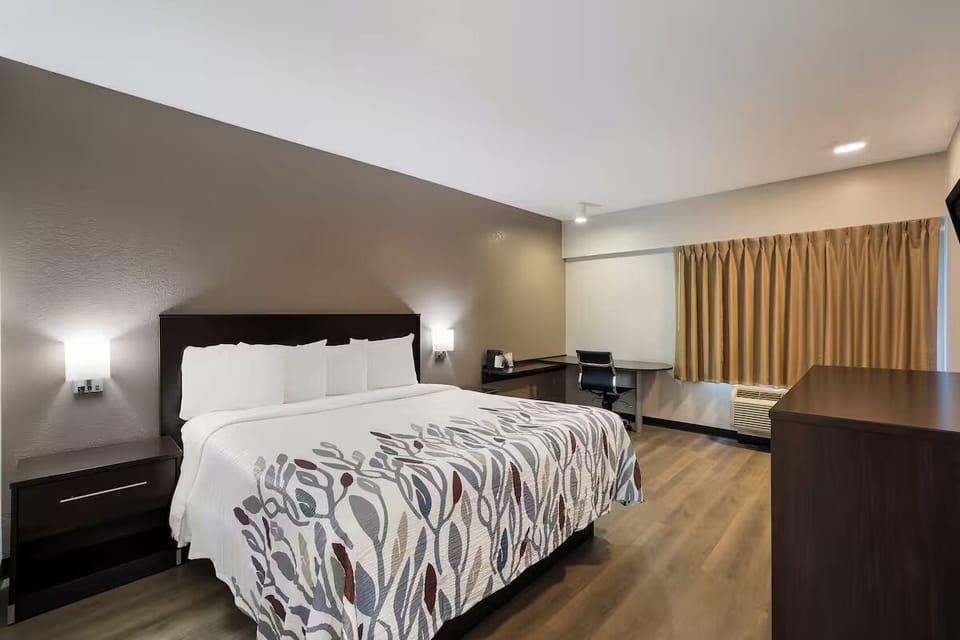 Stretch out on a plush king bed under warm lighting.