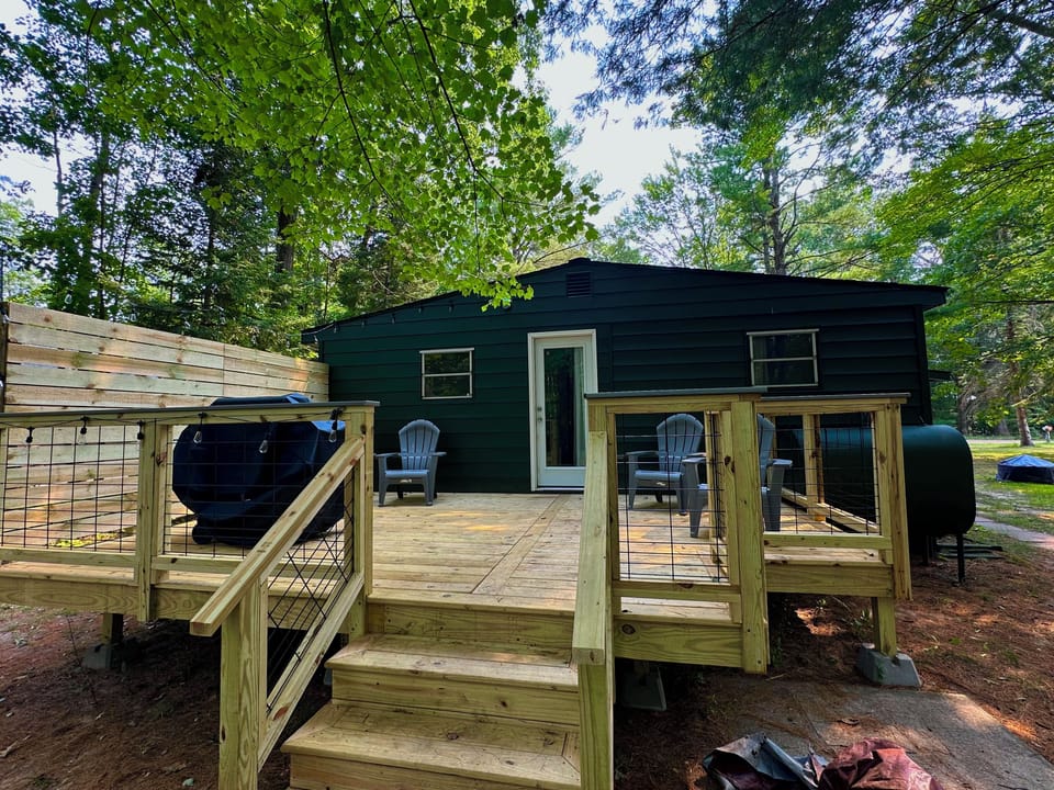 Deck off master bedroom, with grill and chairs 