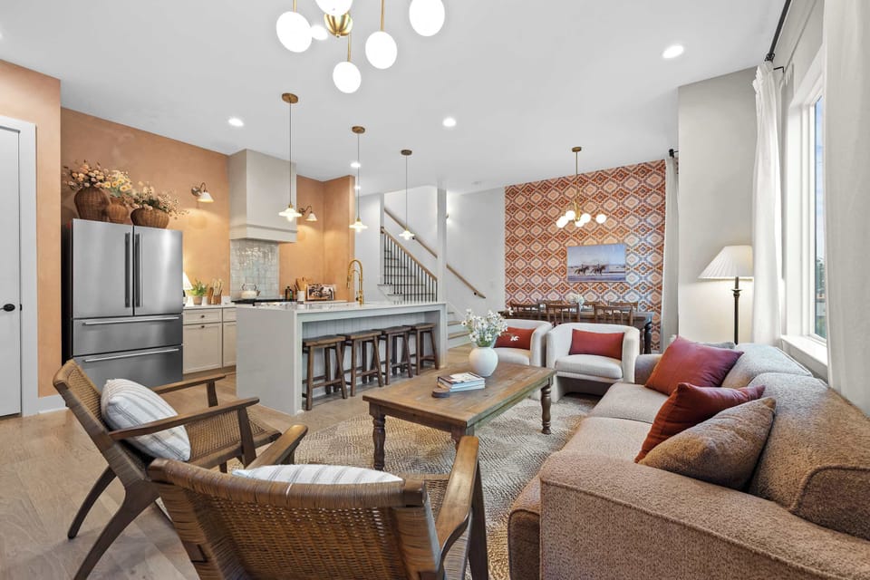 Full open-concept floor plan with chef's kitchen, dining area, staircase access, and living room. 