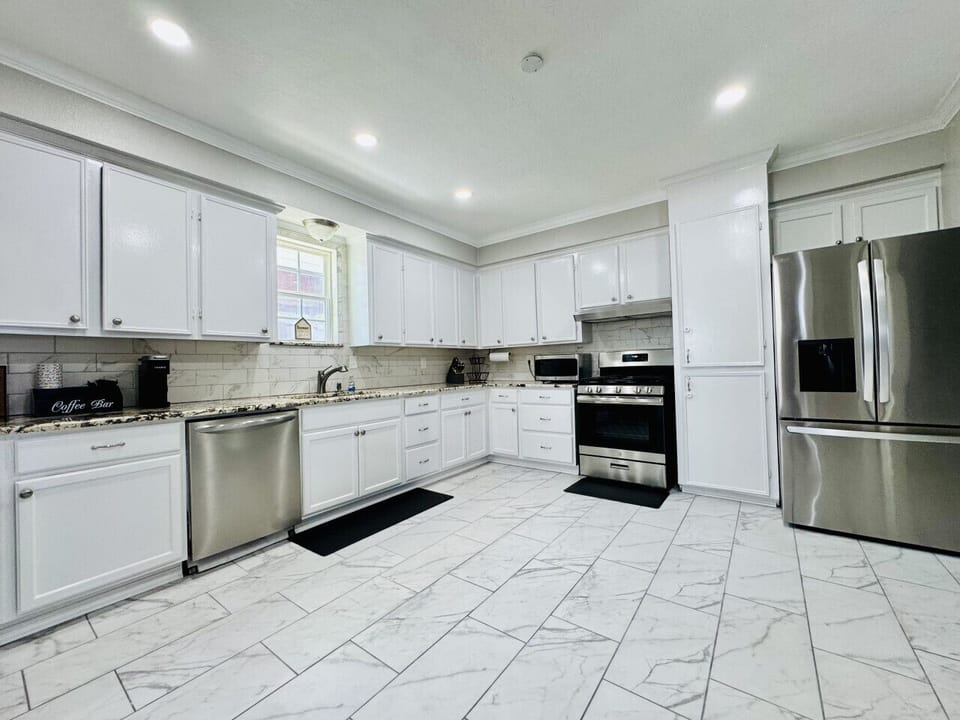 Airy kitchen features a gas stove with built-in iron griddle