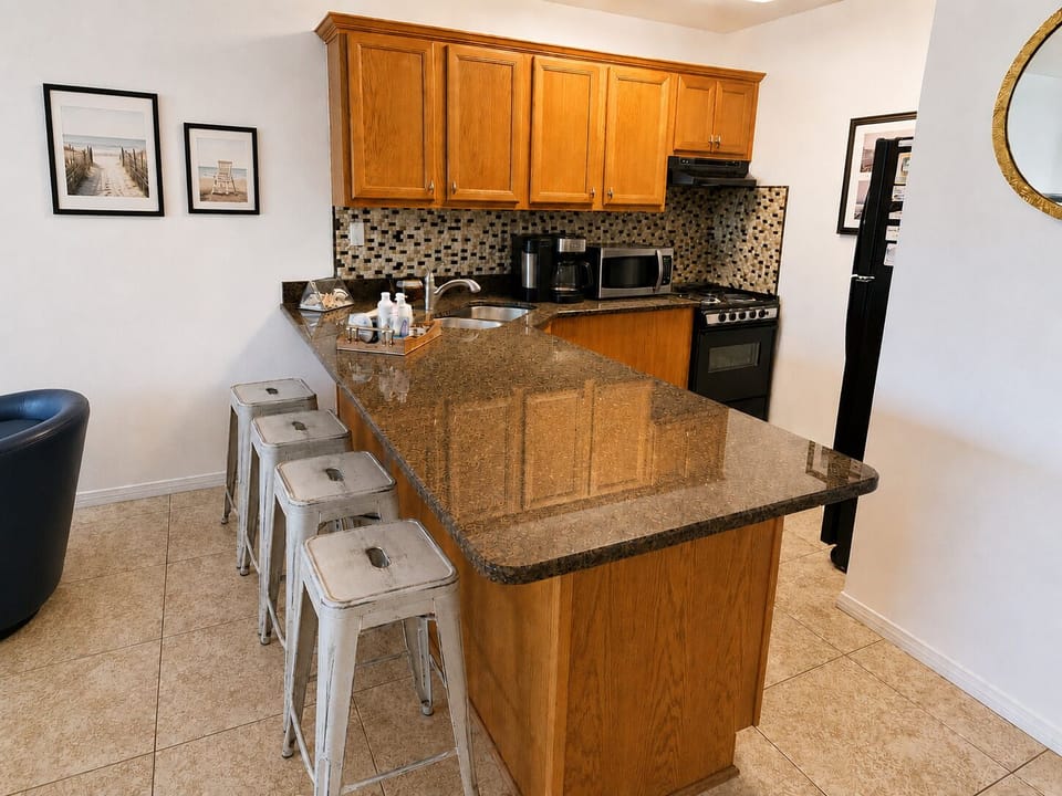 Spacious kitchen with granite breakfast bar and seating for four