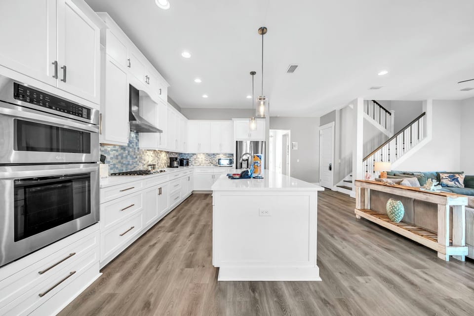 A full stainless suite, generous counter space, and an island that doubles as a gathering spot — this kitchen handles everything from sunrise smoothies to seafood feasts.