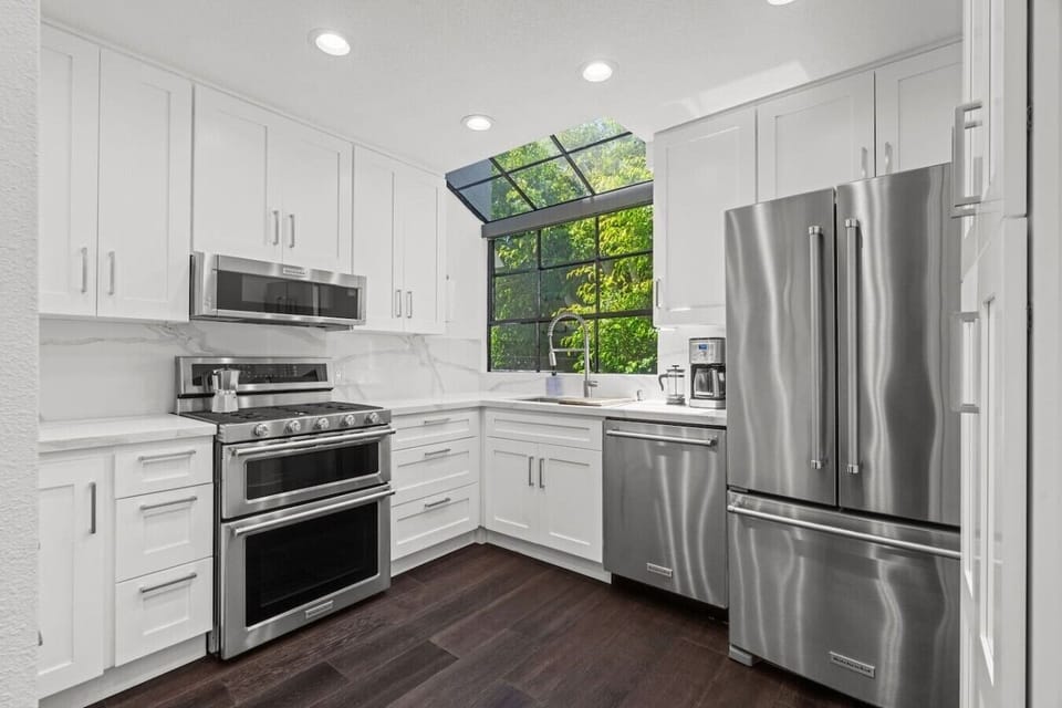 Fully equipped for daily cooking, the kitchen has everything you need — including multiple coffee options and two bar stools at the counter for a casual morning.