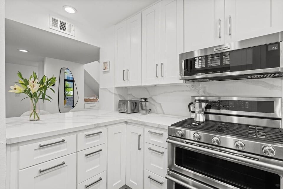 A clean, well-stocked kitchen flows directly into the dining area, making it easy to cook, eat, and settle into a comfortable routine.
