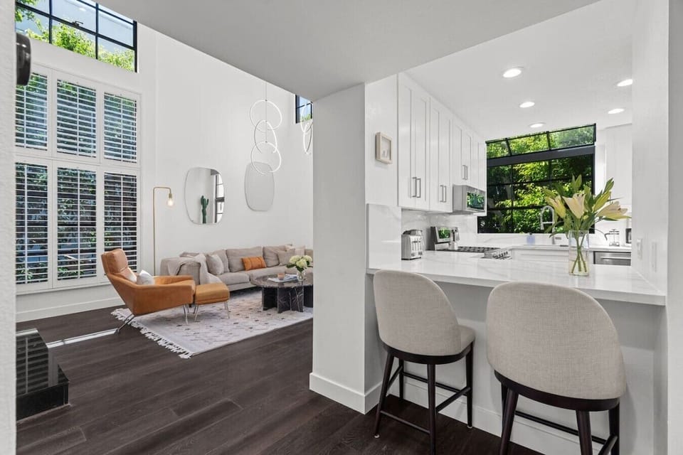Fully equipped for daily cooking, the kitchen has everything you need — including multiple coffee options and two bar stools at the counter for a casual morning.