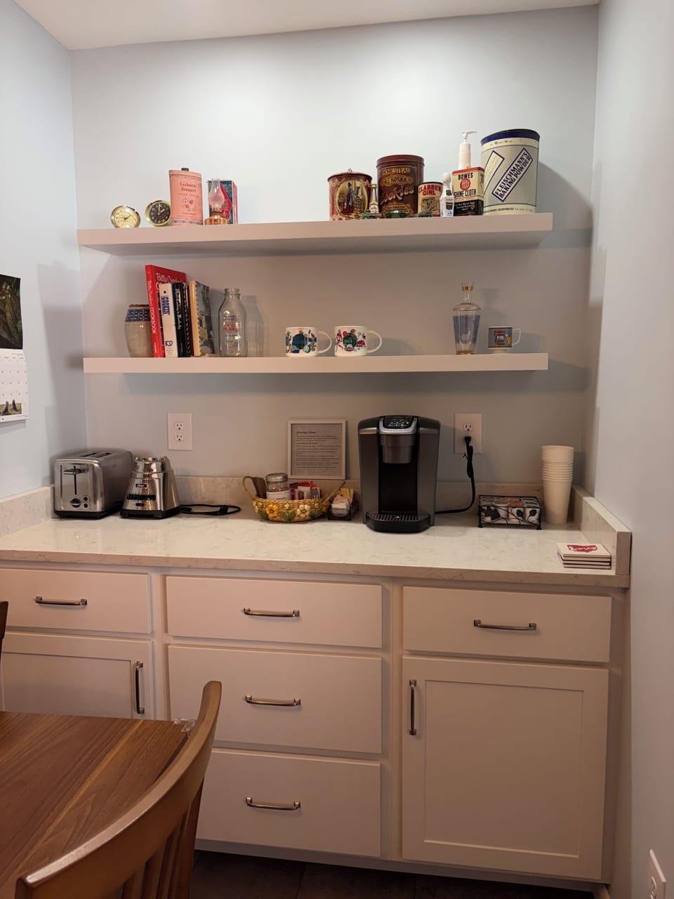 Coffee, tea, cocoa, mugs & to-go cups. Top shelf: Cool vintage decor to view.