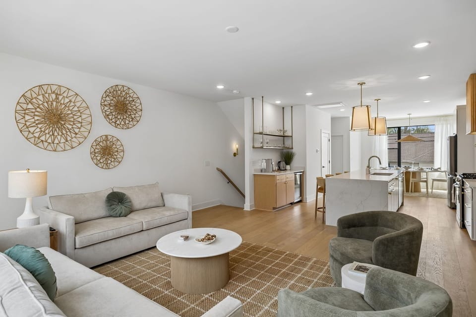 Living Room: A sun-filled living room with big windows, a sofa, and a TV for cozy evenings.