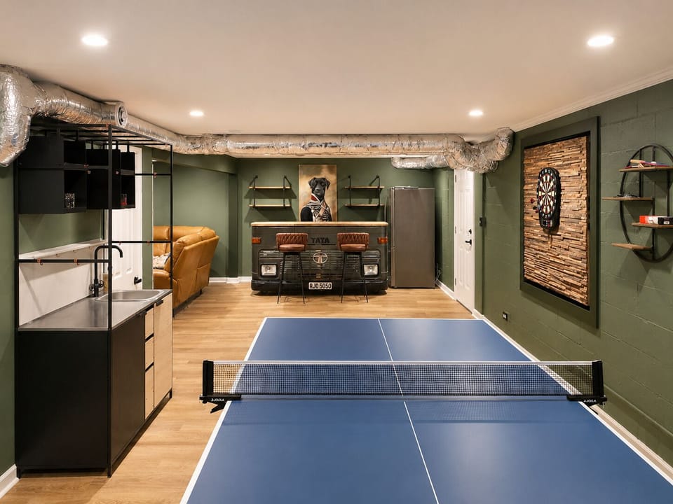 Game room view with ping pong, wet bar, lounge seating and an easy setup for family game nights.