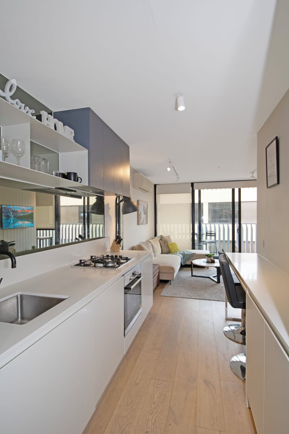 Bright open-plan kitchen and lounge with balcony access