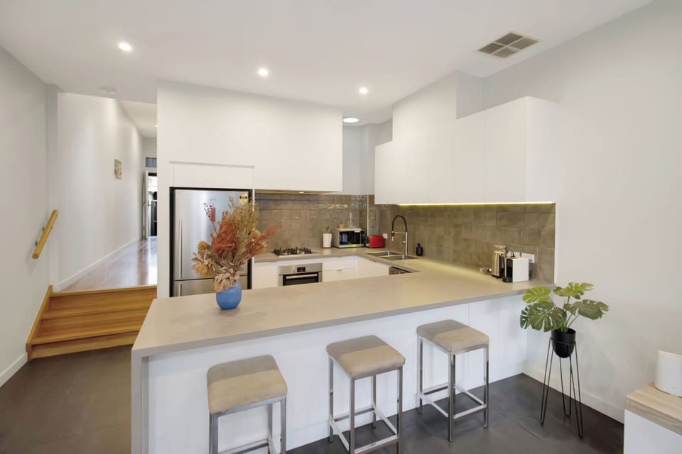 Bright modern kitchen with breakfast bar and sleek contemporary finishes