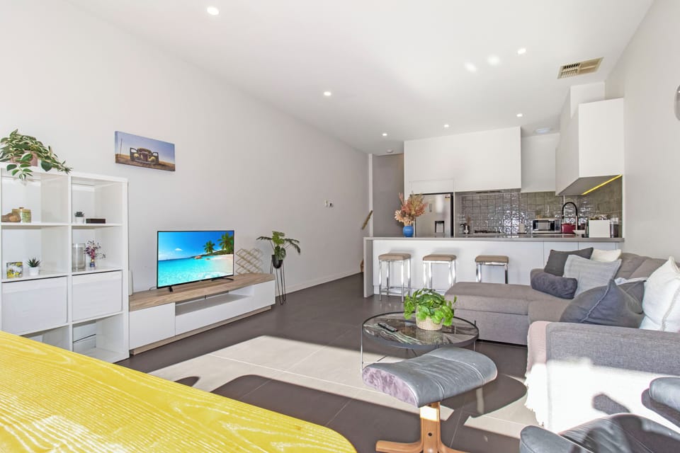 Bright open-plan living with modern kitchen, breakfast bar & comfy lounge