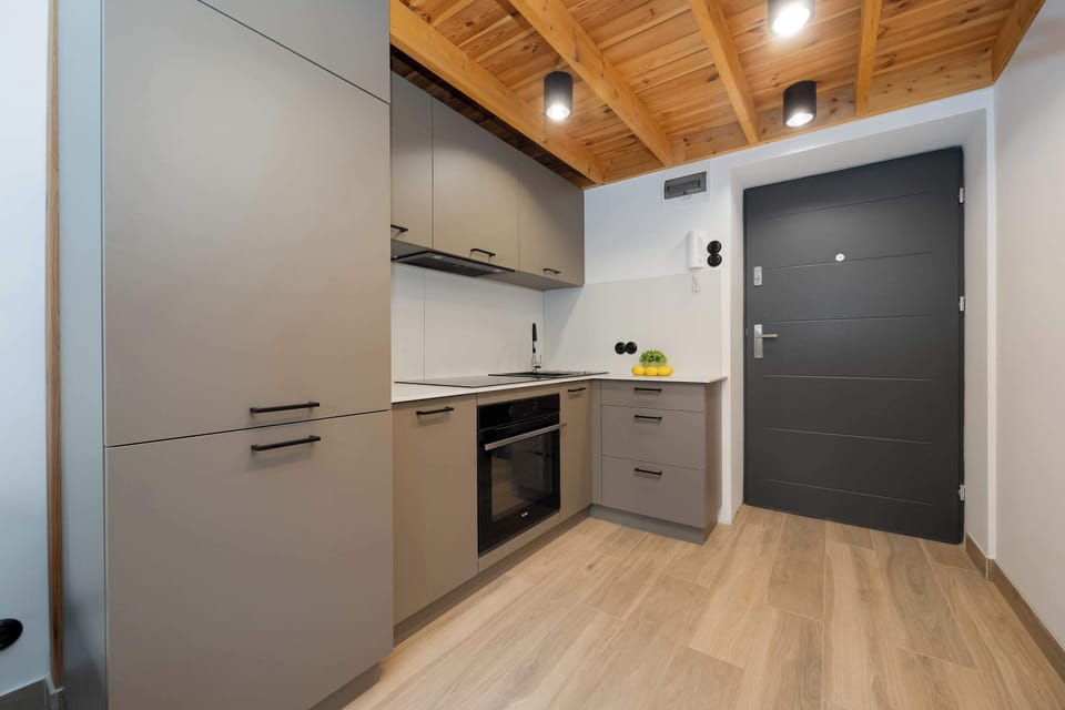 Modern kitchenette equipped with essential appliances and storage space.