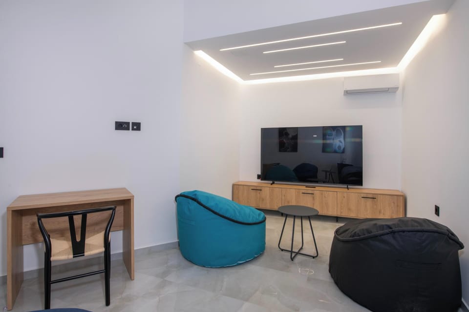 The playroom features a 75” TV, a PlayStation 5, and four poof loungers.
