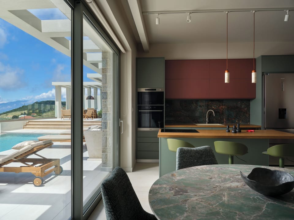 A seamless open-plan living and kitchen area opens directly to the pool, creatin