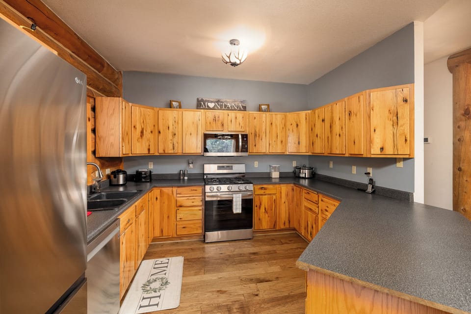 Open concept kitchen with stainless steel appliances | Main Level