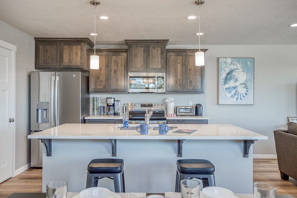 Your fully equipped kitchen welcomes you with modern appliances, stylish cabinetry, and a spacious island perfect for morning coffee or meal prep.