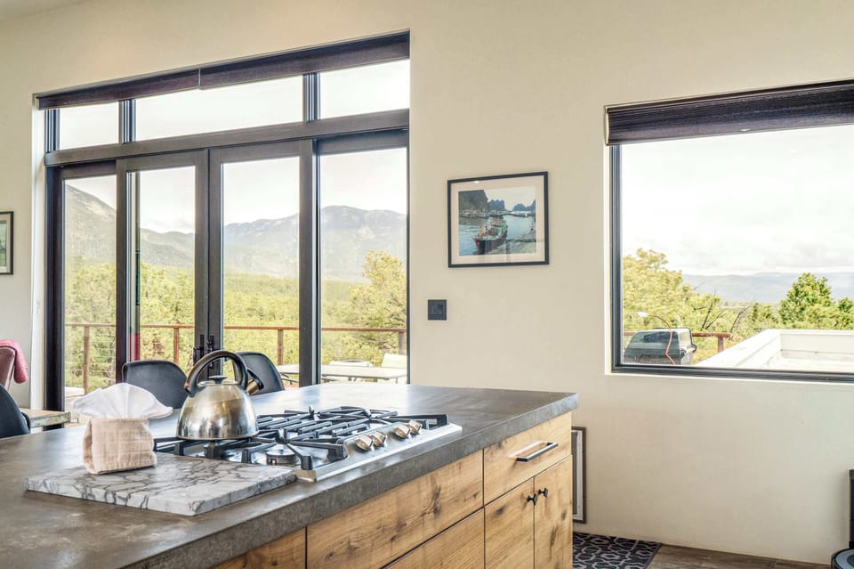 Gas cooktop on the concrete island, steps from the deck