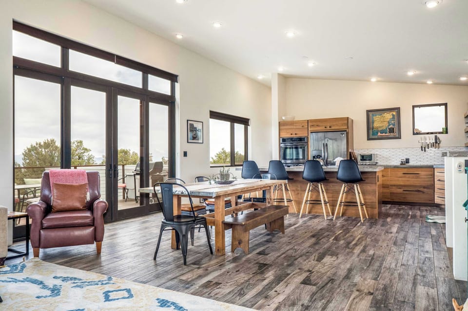 Open dining and kitchen with French doors to the deck