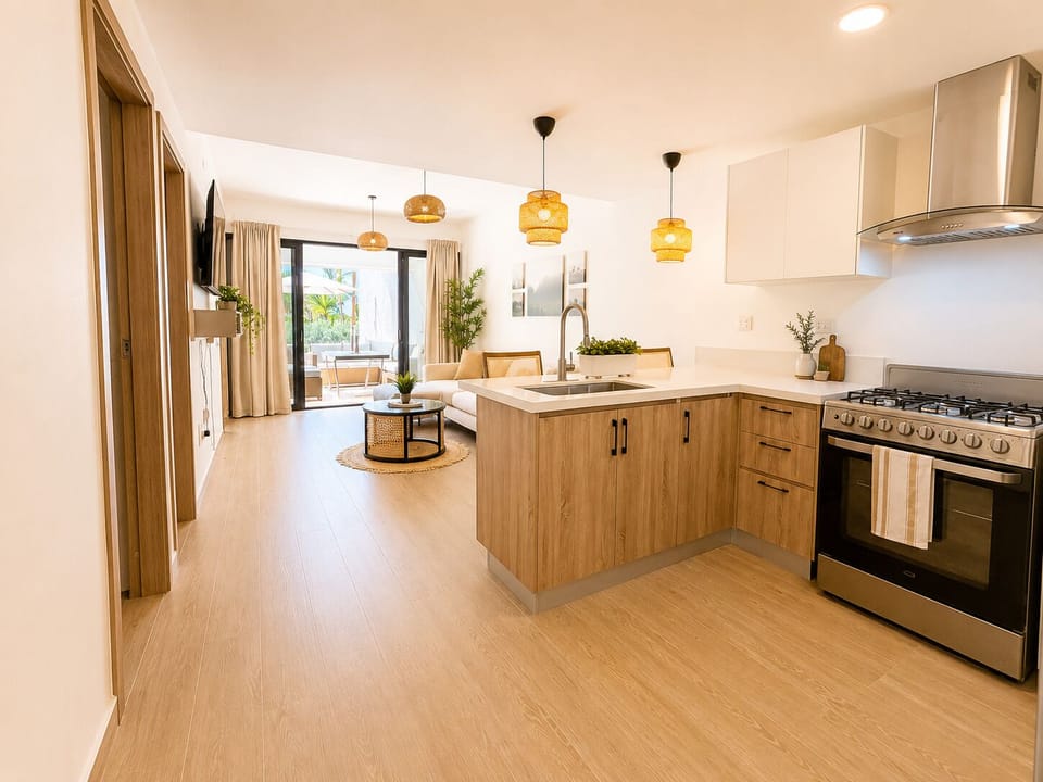 Open-plan kitchen and living area with modern appliances and access to a sunny patio.