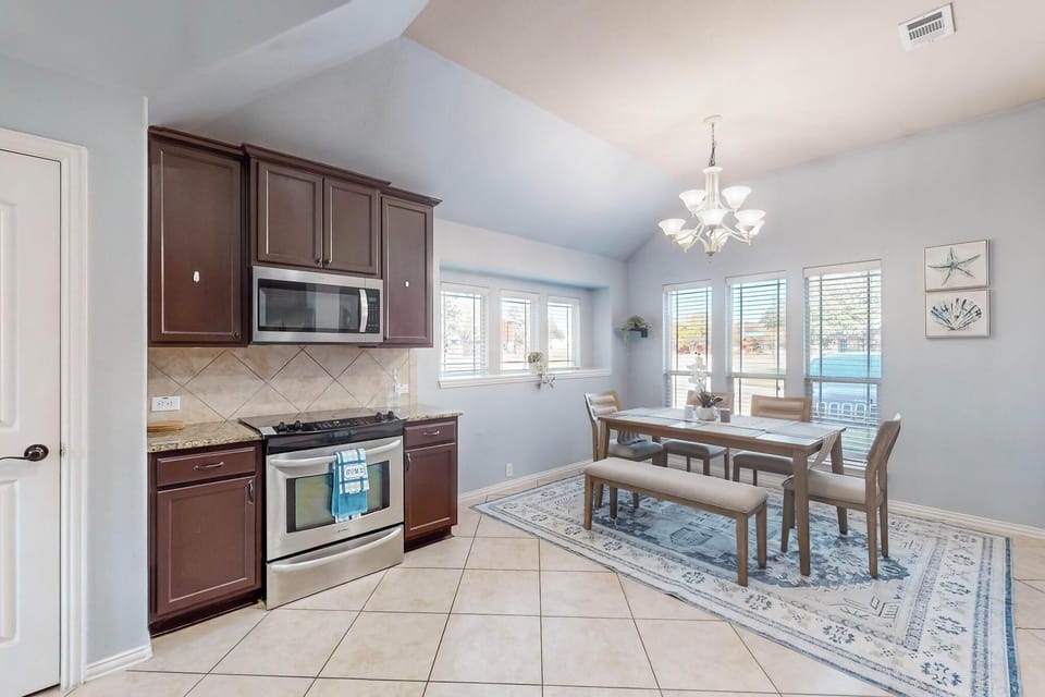 A bright, open kitchen and dining space awaits, featuring sleek cabinetry, modern appliances, and a welcoming table where you can enjoy meals in natural light.