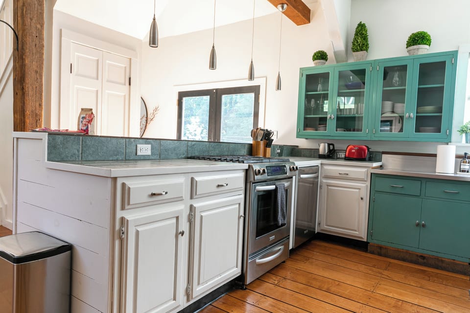Fully equipped kitchen with stainless steel appliances & hardwood floors