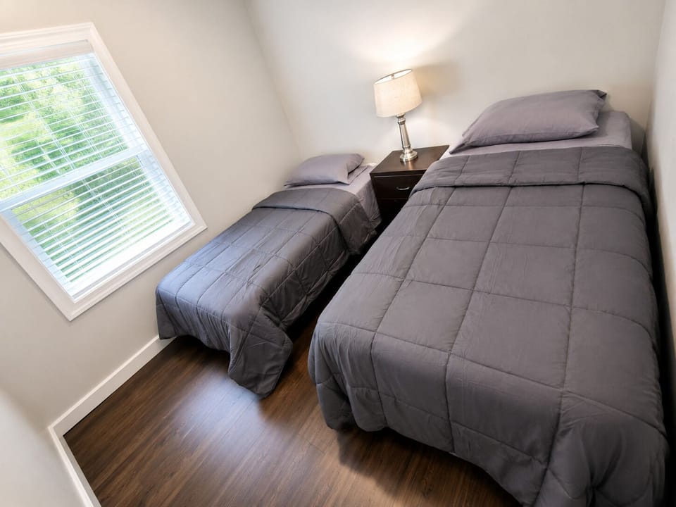 Bright twin bedroom with natural light and comfortable sleeping setup