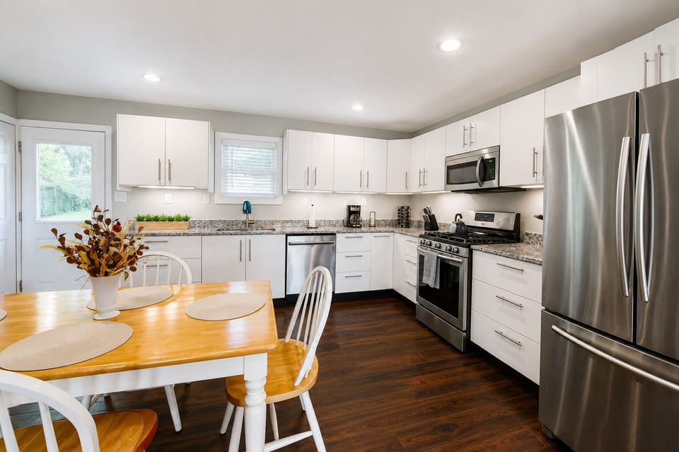 Bright modern kitchen with stainless appliances and cozy dining area