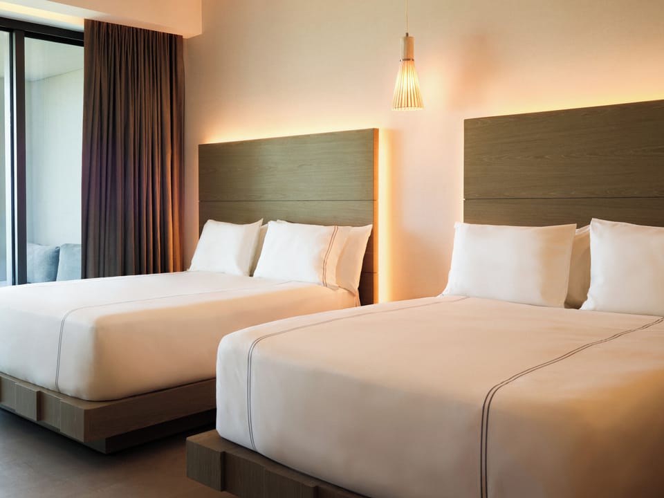 Stretch out on crisp linens in a bright, restful twin room.